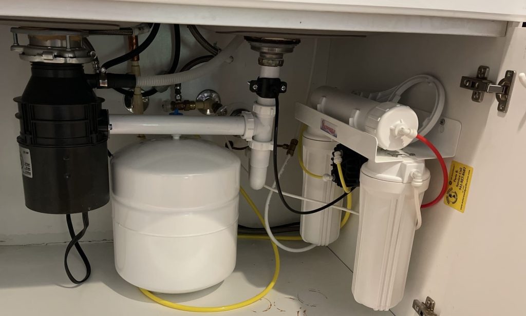 reverse osmosis water system underneath bathroom sink in bradenton home